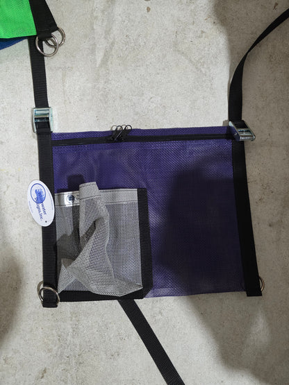 Purple pouch with gray mesh pocket on a concrete surface
