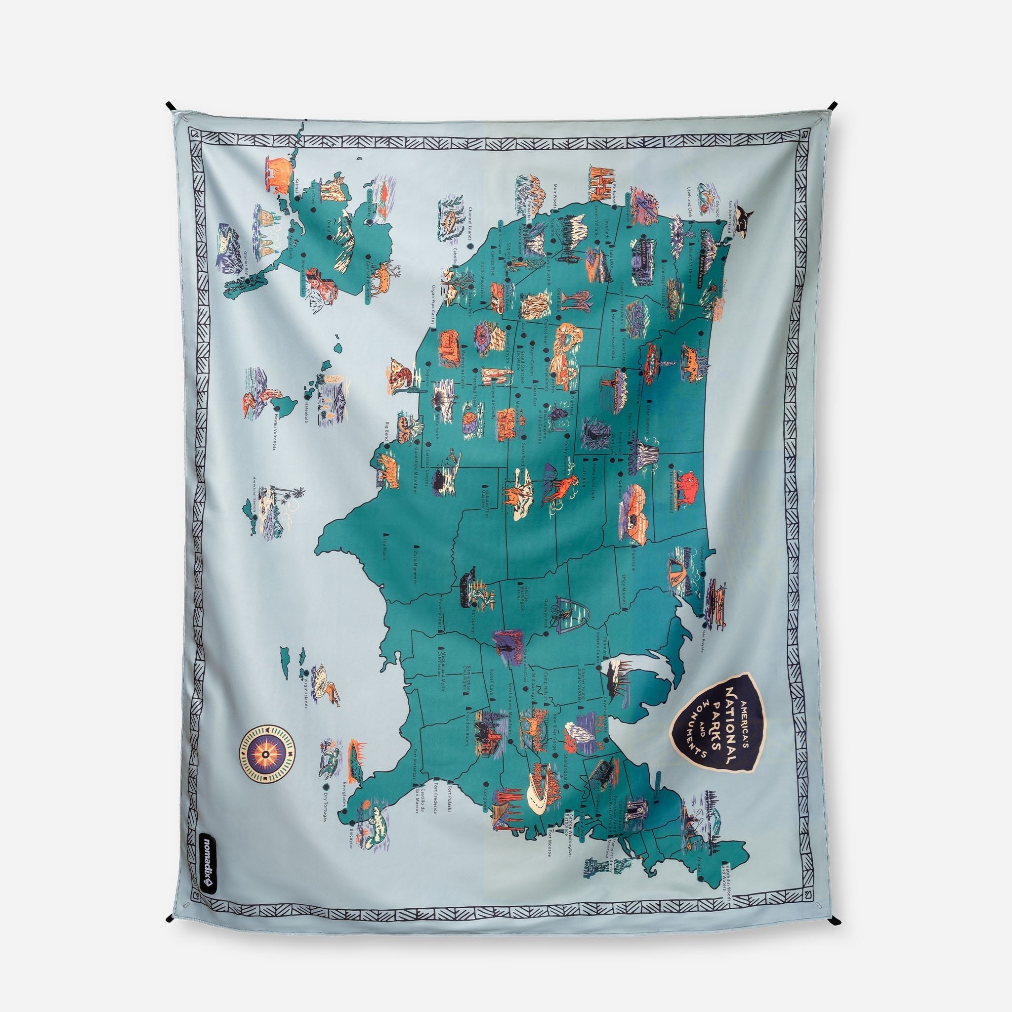 Map-themed decorative blanket with colorful illustrations on a light gray background