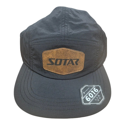 SOTAR five-panel performance hat in black nylon with a brown faux-leather logo patch on the front.